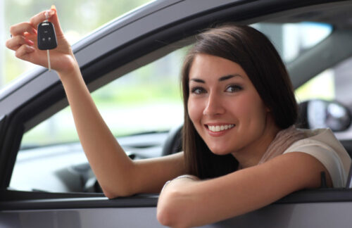 Happy smiling woman with car key. Driving Happy smiling woman with car key. Driving